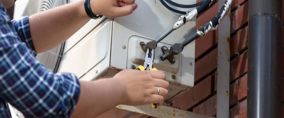 closeup-of-male-technician-repairing-outdoor-air-c-2021-12-09-17-34-31-utc-min-min.jpg